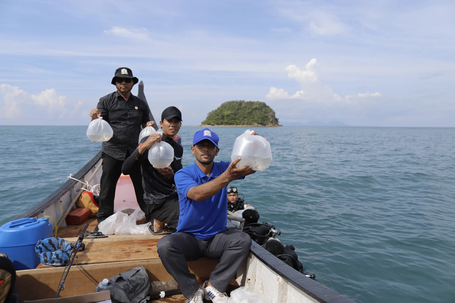 Aceh Aquatic Youth members smiling on a boat after marine conservation field work